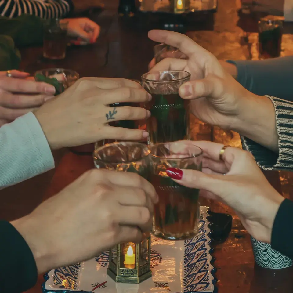 Guests raising their tea glasses
